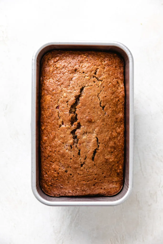 Loaf of bread in a metal pan.