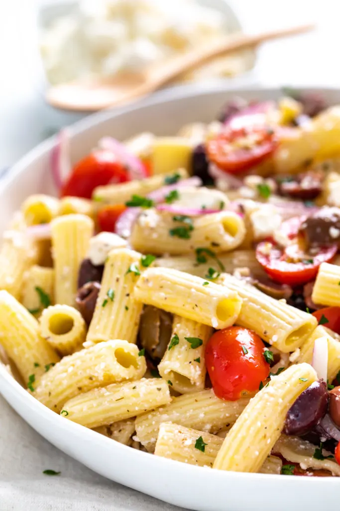 Close up view of pasta salad with greek dressing.