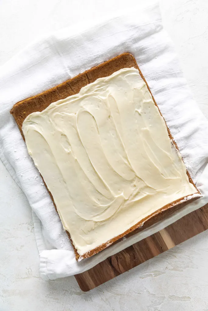 Cream cheese filling spread over the inside of a pumpkin roll.