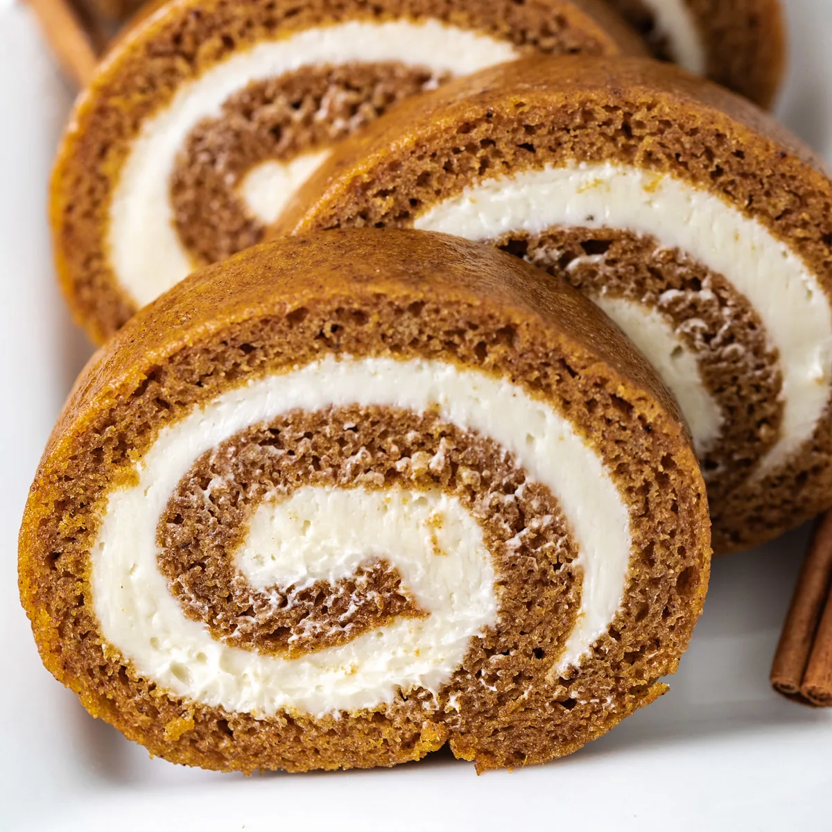 Close up view of a sliced pumpkin roll.