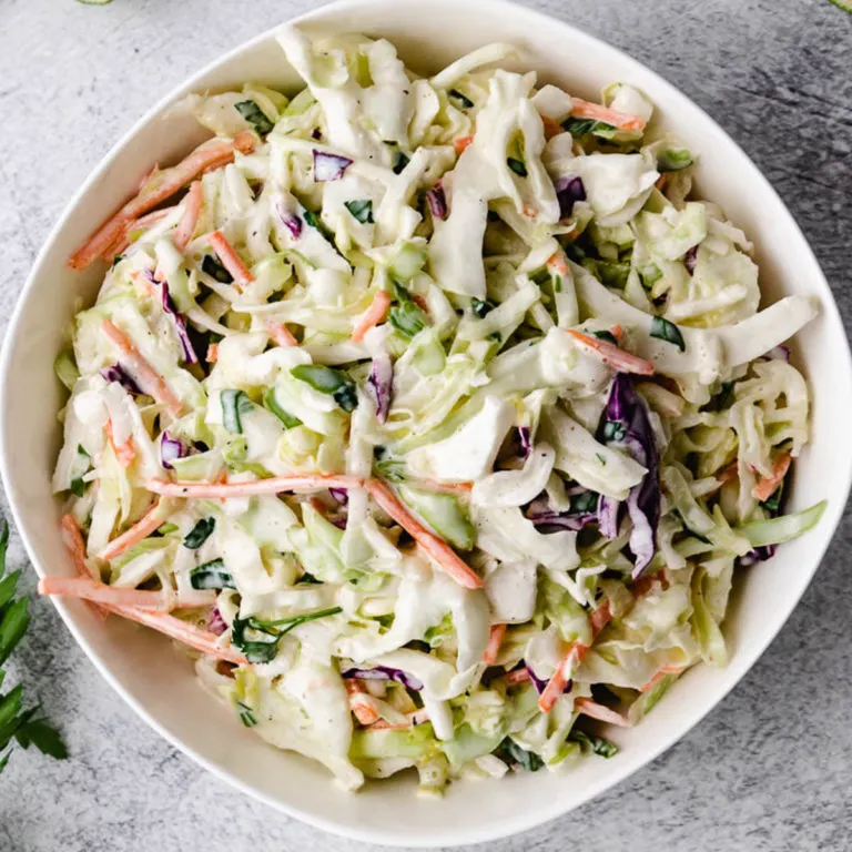 Top down view of creamy taco slaw in a bowl.