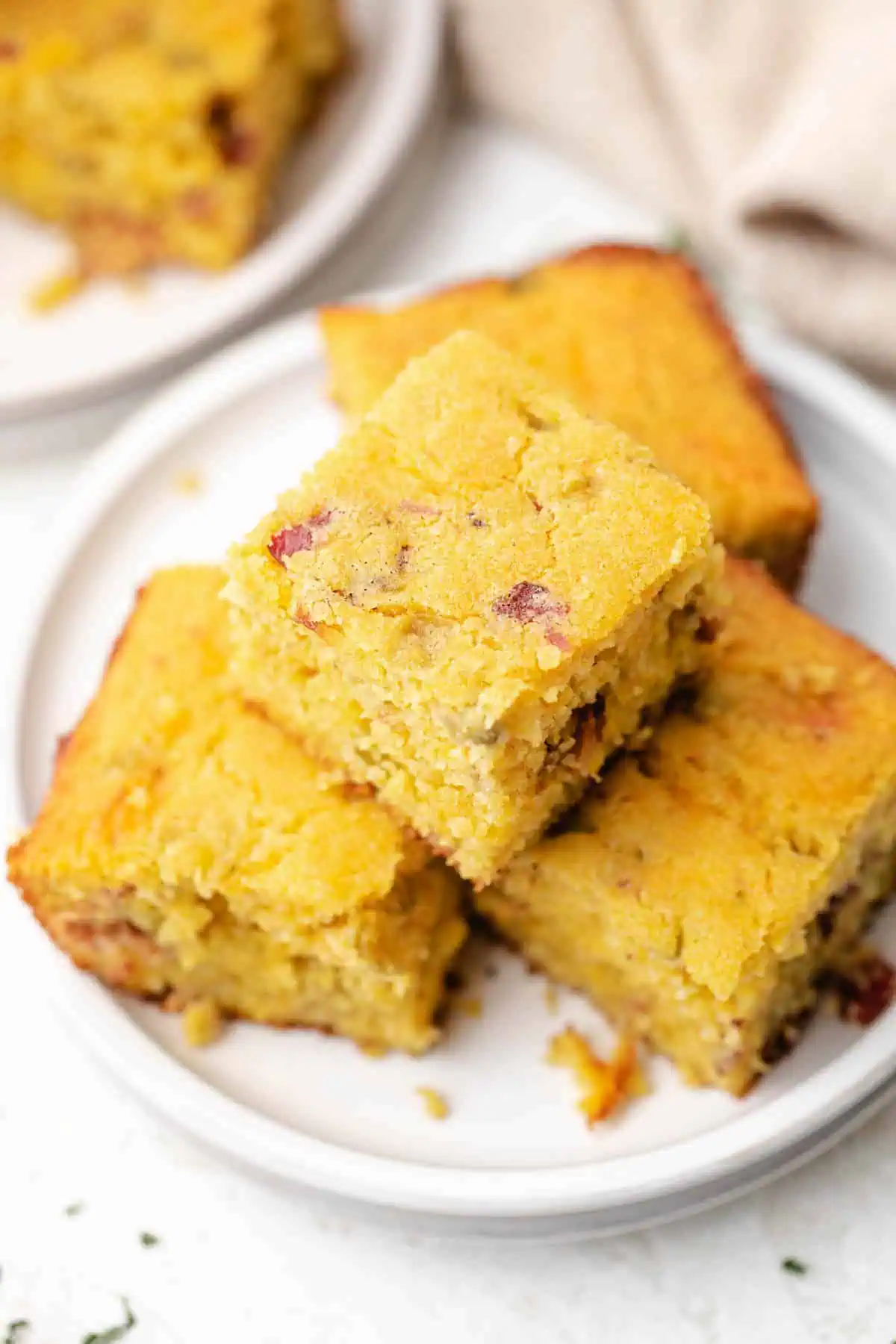 Top down view of cornbread on a plate.