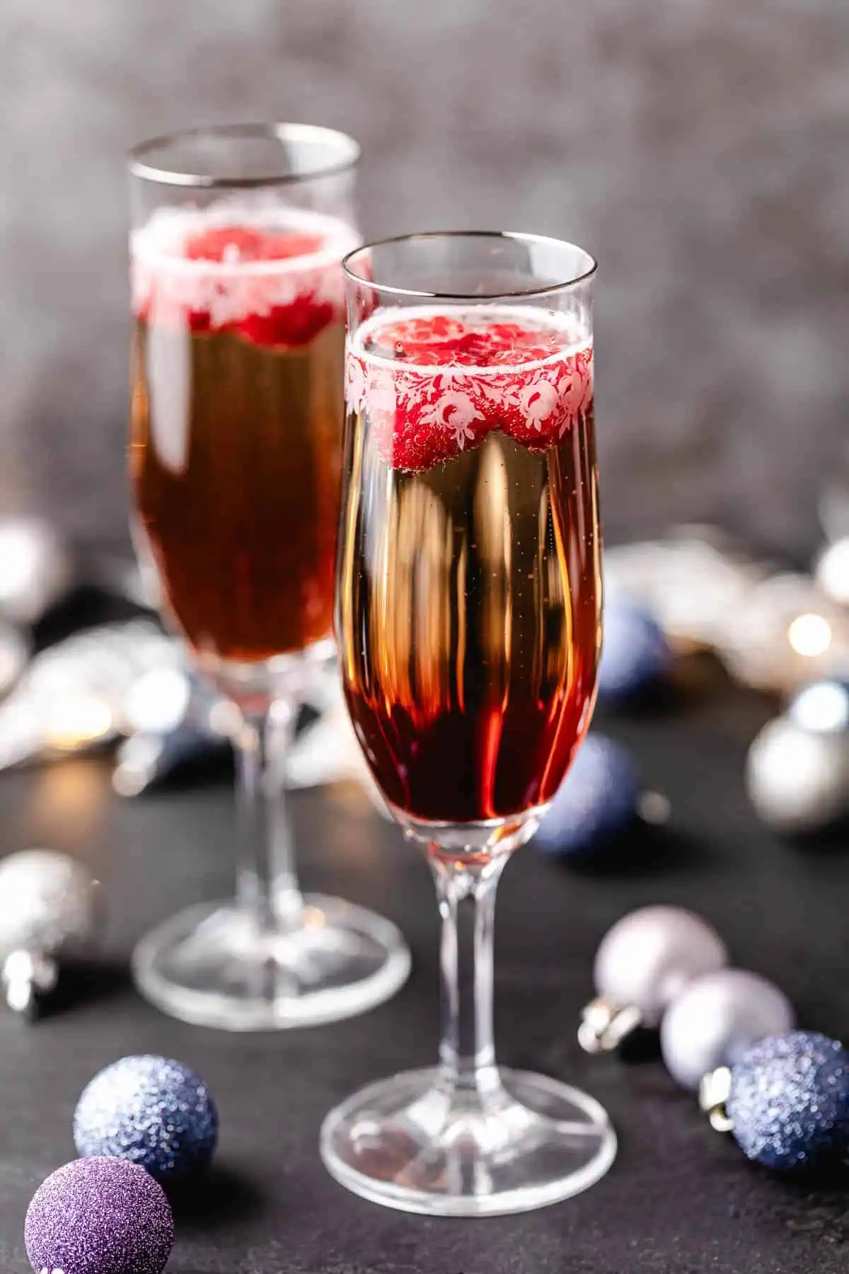 Side view of glasses of chambord and prosecco.