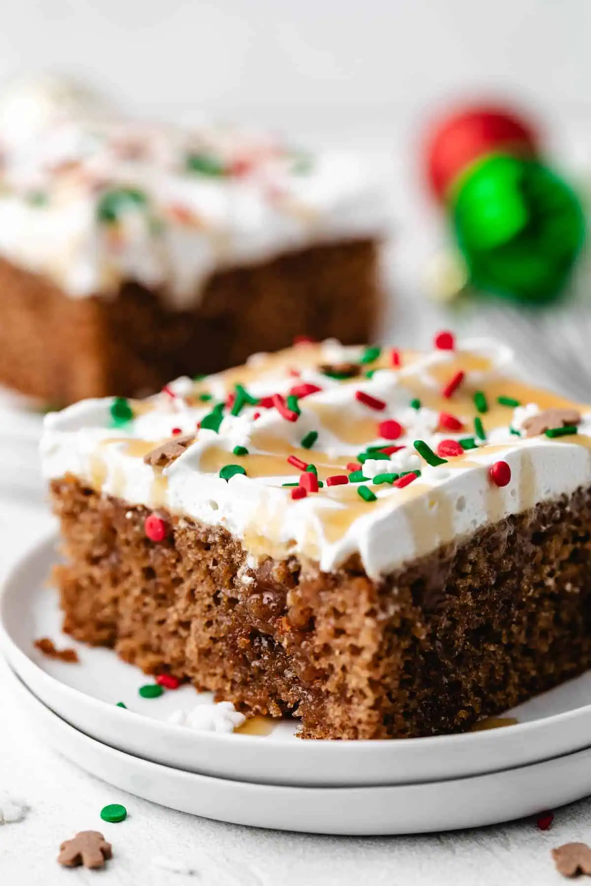 Christmas sprinkles on a cake with whipped topping.