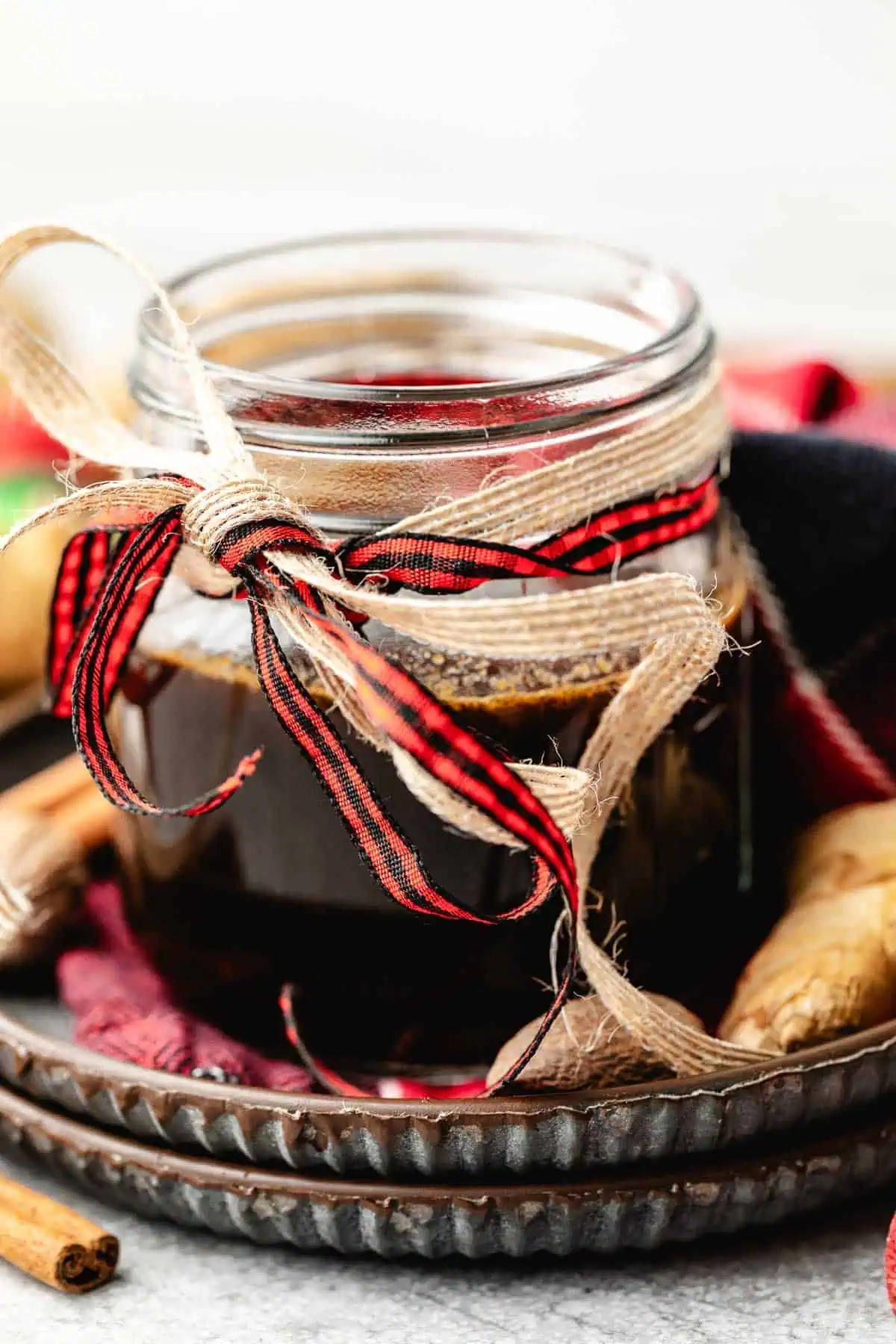 Close up view of holiday simple syrup in a small glass jar.