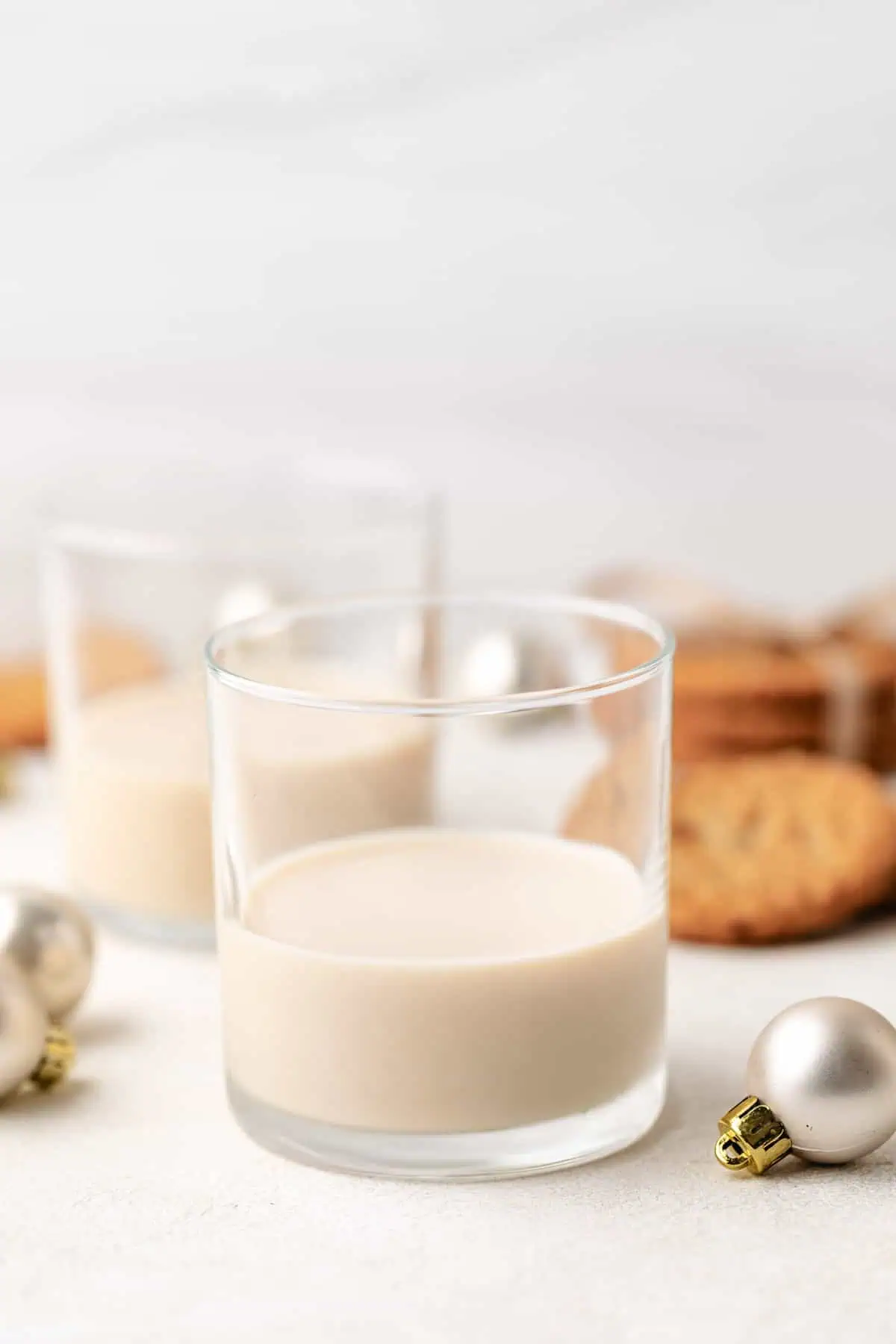 Christmas ornaments next to a oatmeal cookie drink.