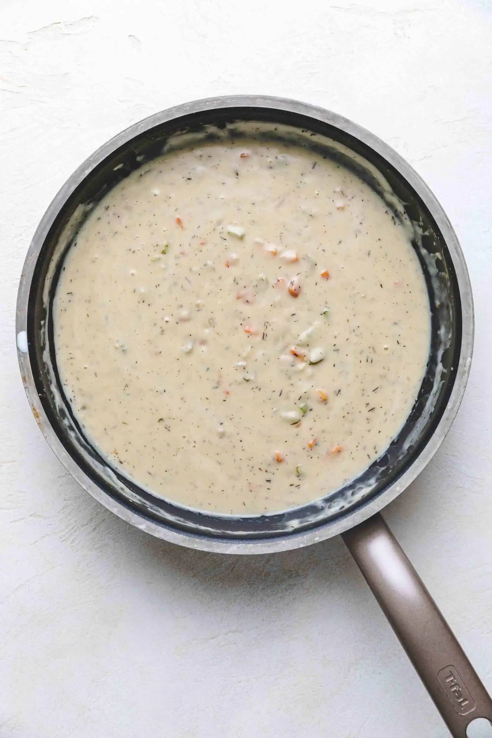 Seasoned gravy in a large pan.