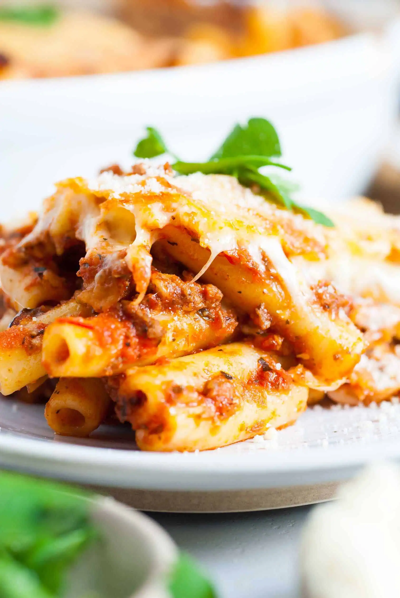 Cheesy baked ziti on a white plate.