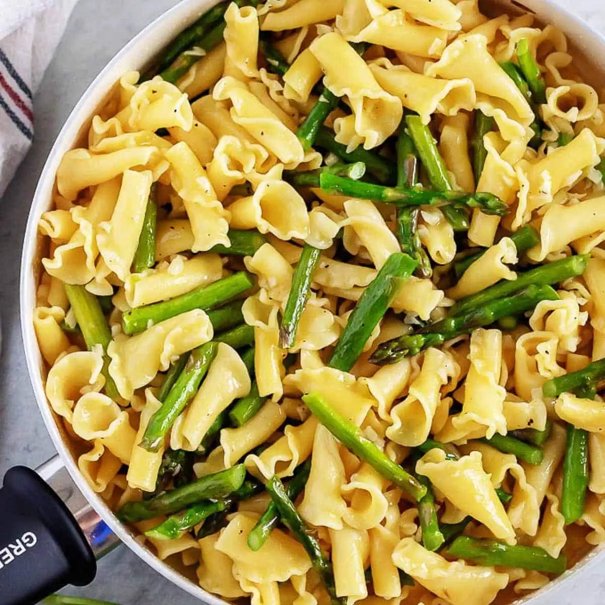 Top down view of a pan of garlic asparagus pasta.