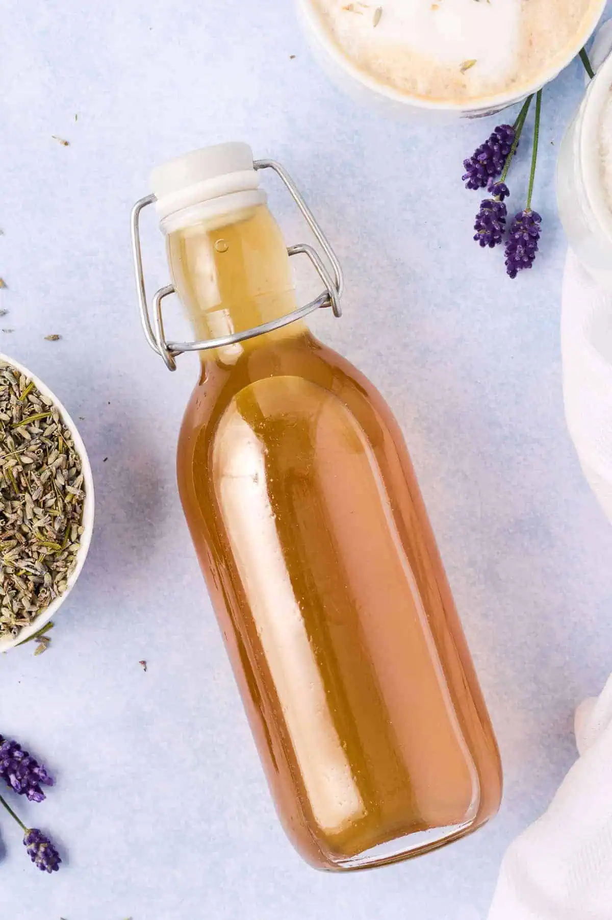 Top down view of a bottle of lavender simple syrup.