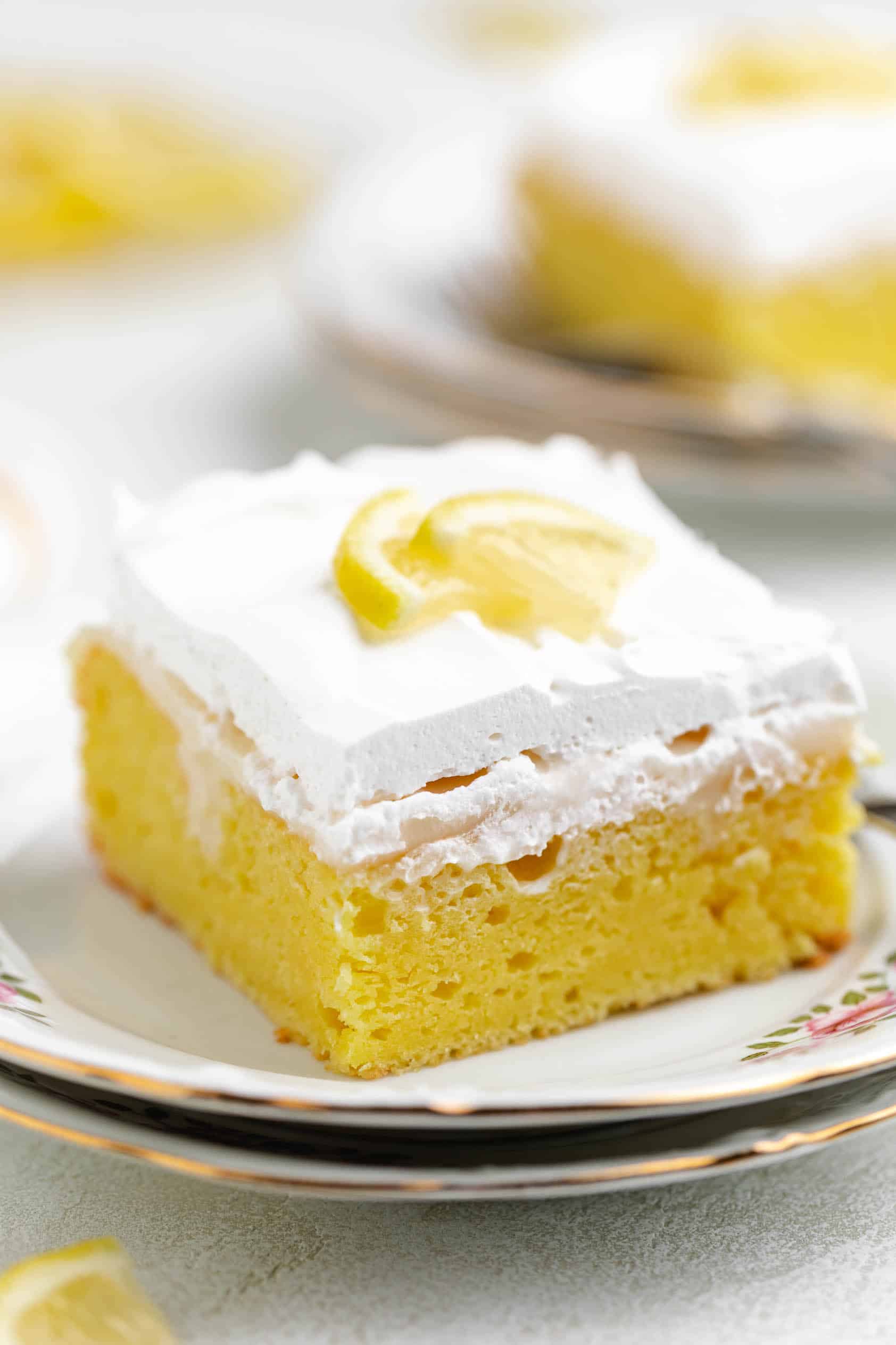 Close up view of lemon cake with whipped cream frosting.