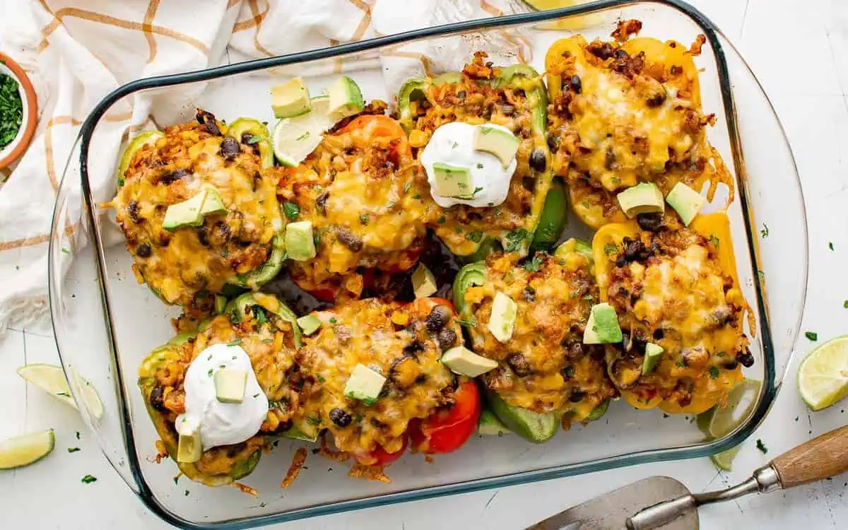 Top down view of stuffed peppers in a pan.