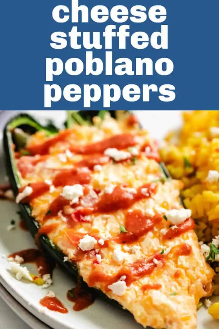 Close up view of a cheesy stuffed poblano on a plate.