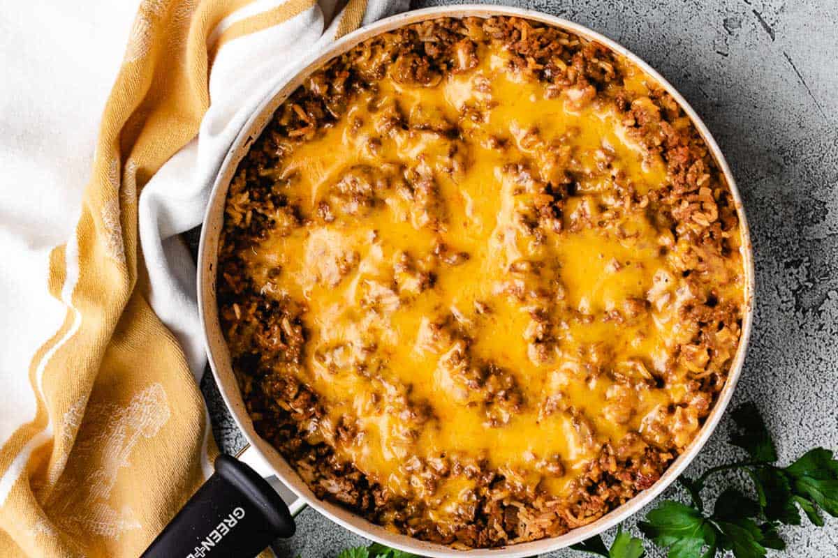 Cheesy beef casserole in a large skillet.