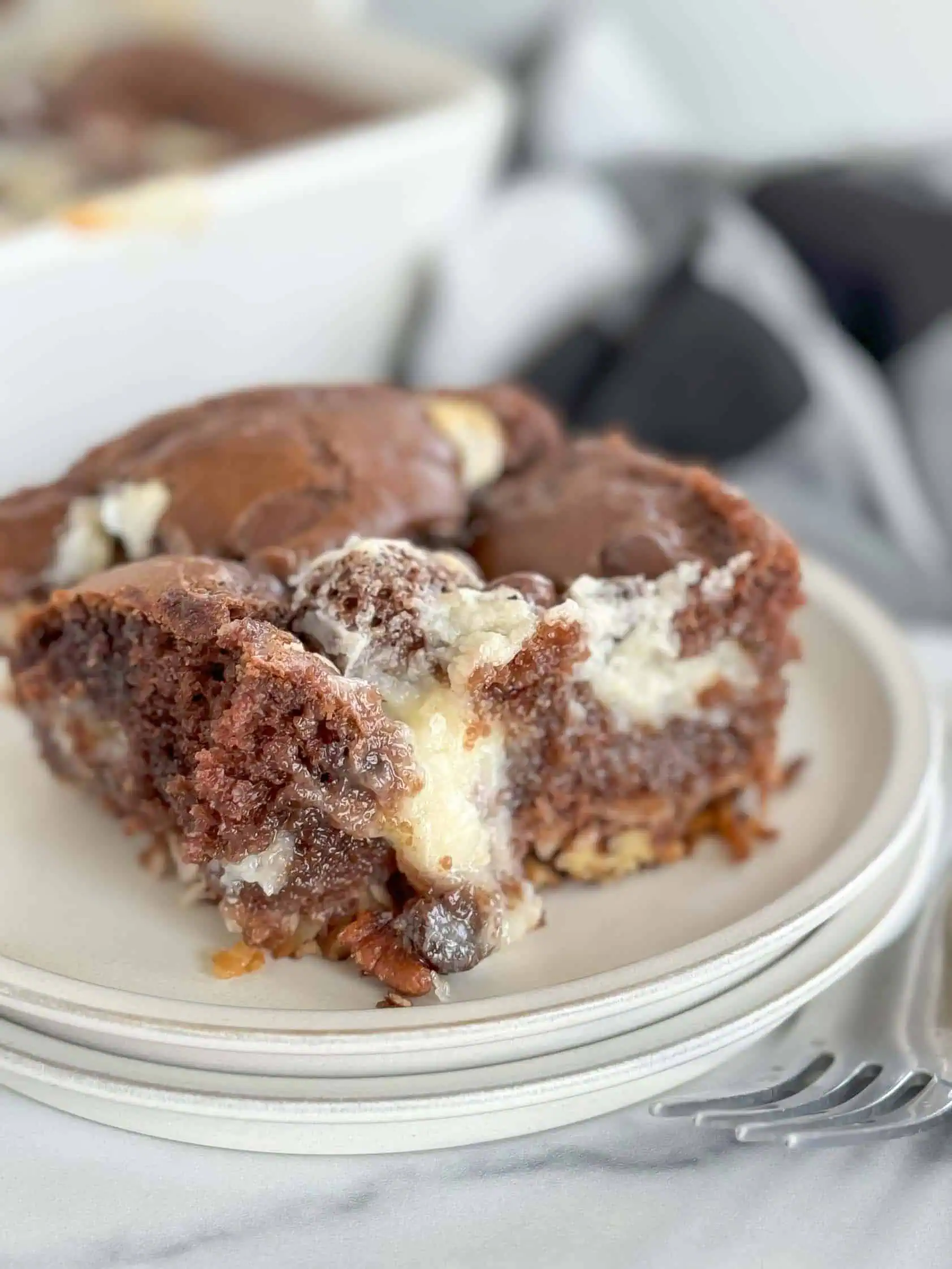 Slice of earthquake cake with cream cheese.