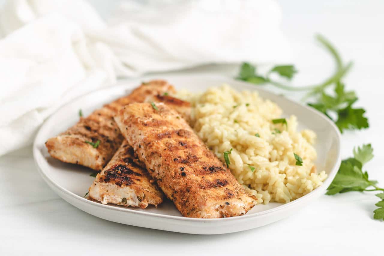 Pieces of grilled mahi mahi on a plate.