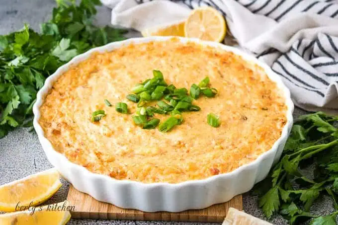 Cheesy crab dip in a white bowl.