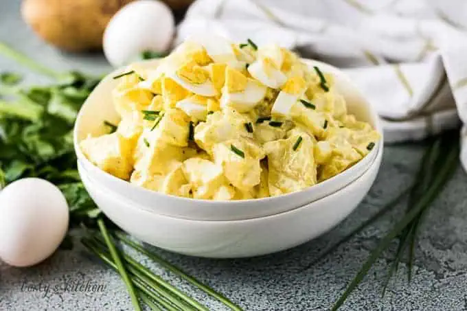 Potato salad in a stack of white bowls.