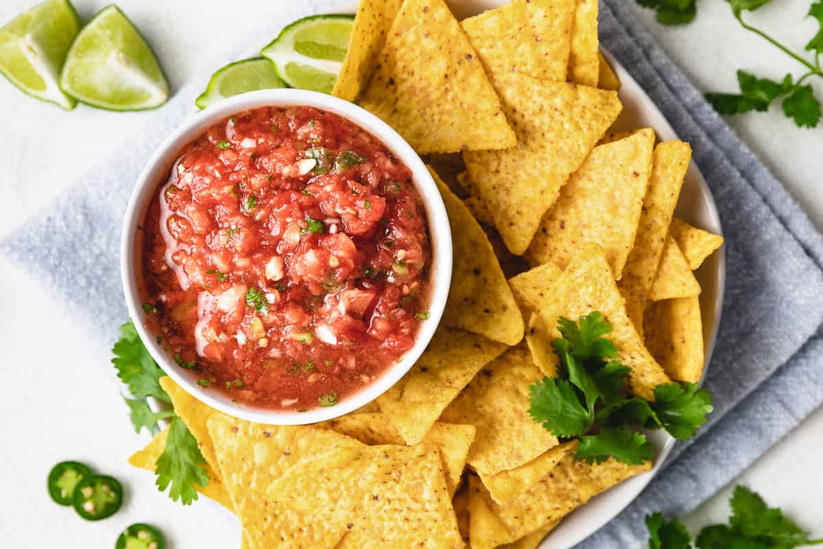 Top down view of serrano salsa next to chips.