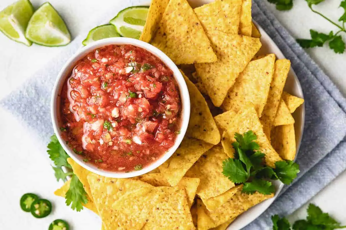 Top down view of serrano salsa next to chips.