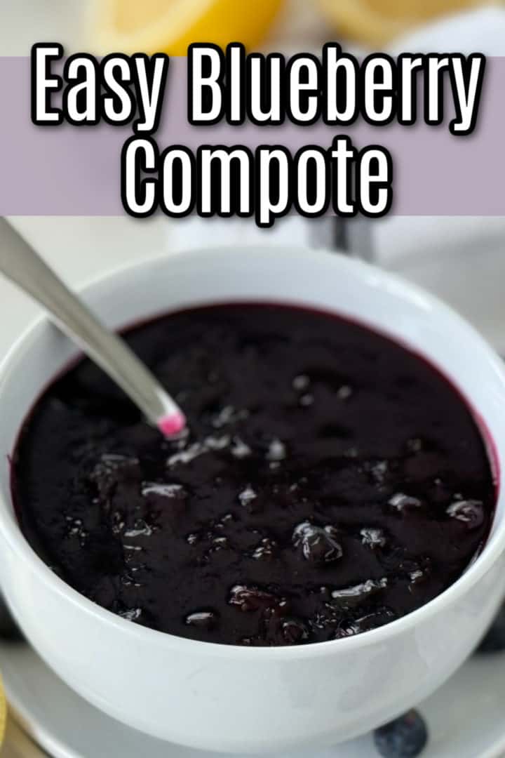 Easy berry sauce recipe in a white bowl with a spoon, surrounded by lemon halves and fresh blueberries on a light background with a striped cloth.