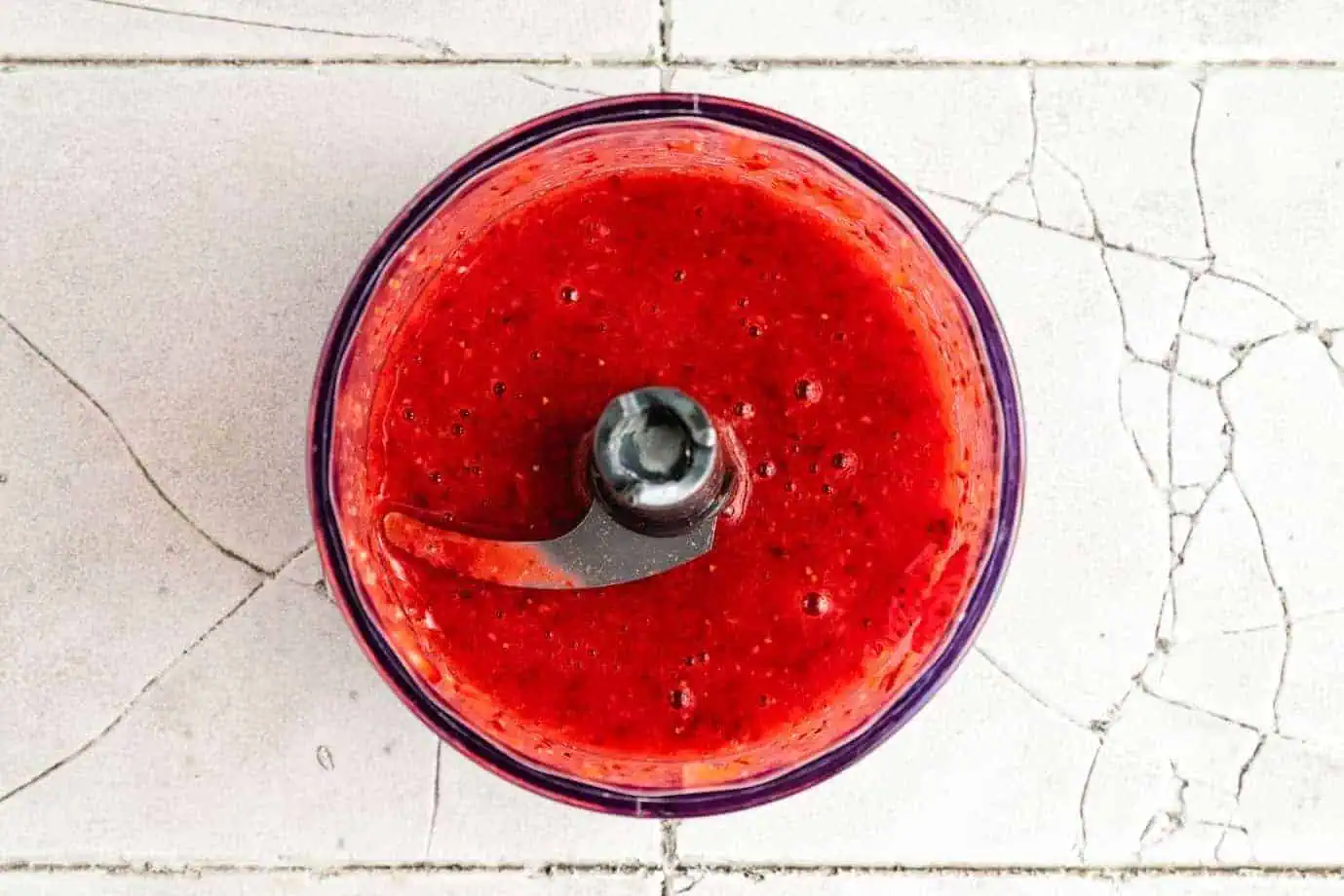 Strawberry puree in a food chopper.