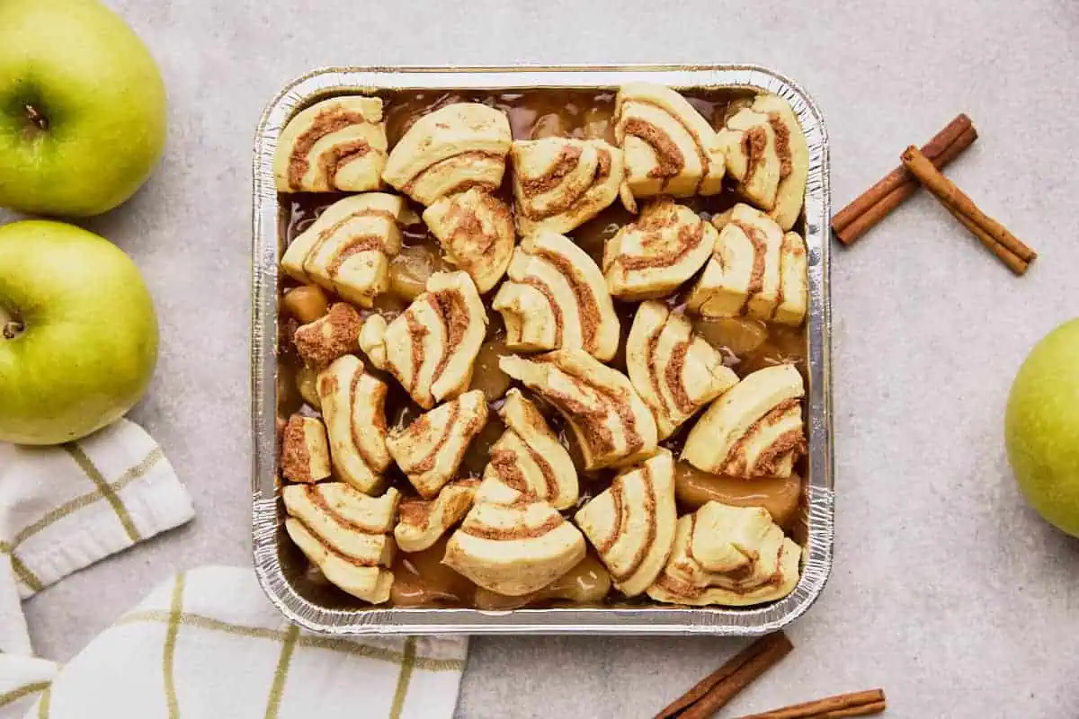 Unbaked cinnamon rolls over pie filling.