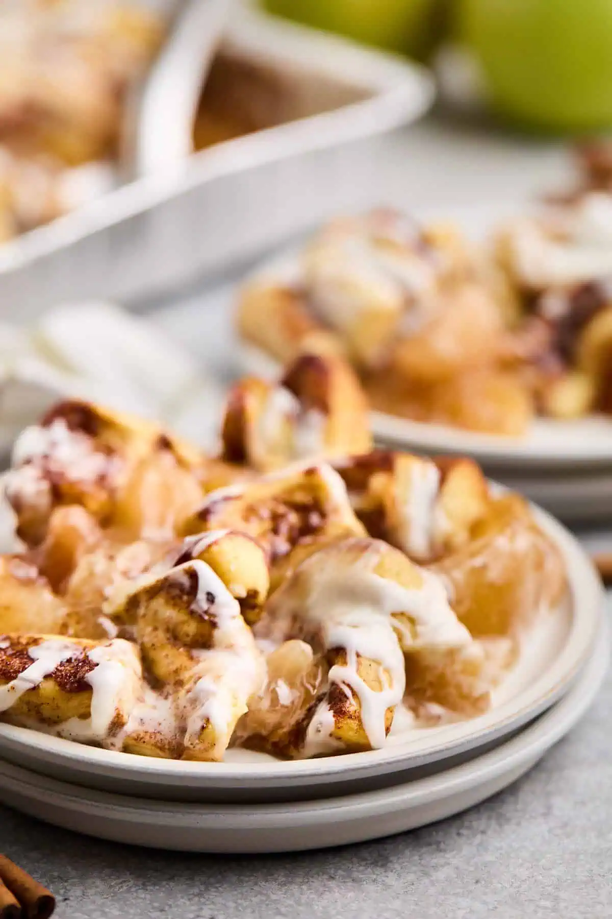 Close-up of cinnamon roll apple cobbler served on a plate, showcasing the gooey apple filling and cinnamon rolls.