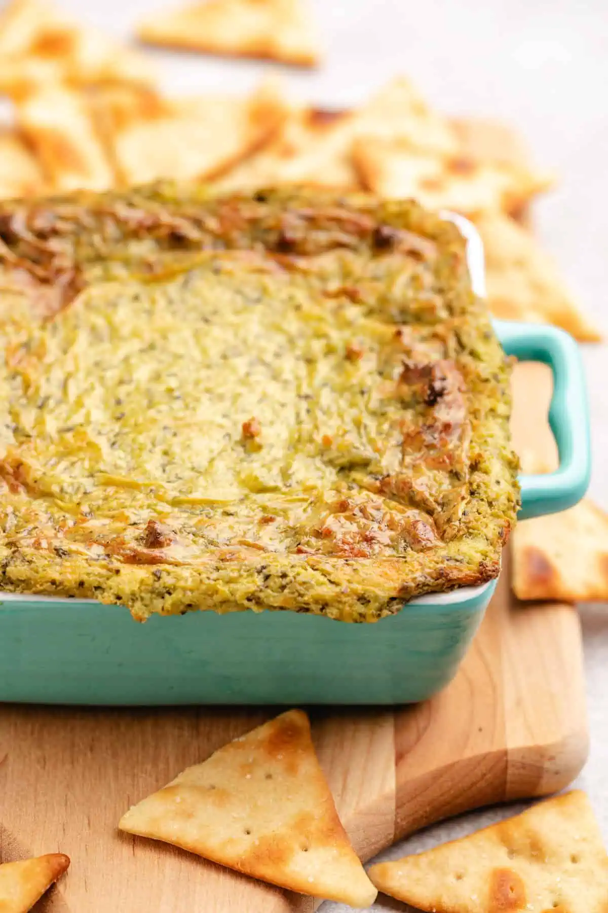 Golden brown baked cheese dip in a dish.