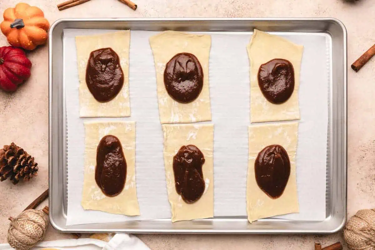 Pumpkin butter filling spread over puff pastry rectangles.