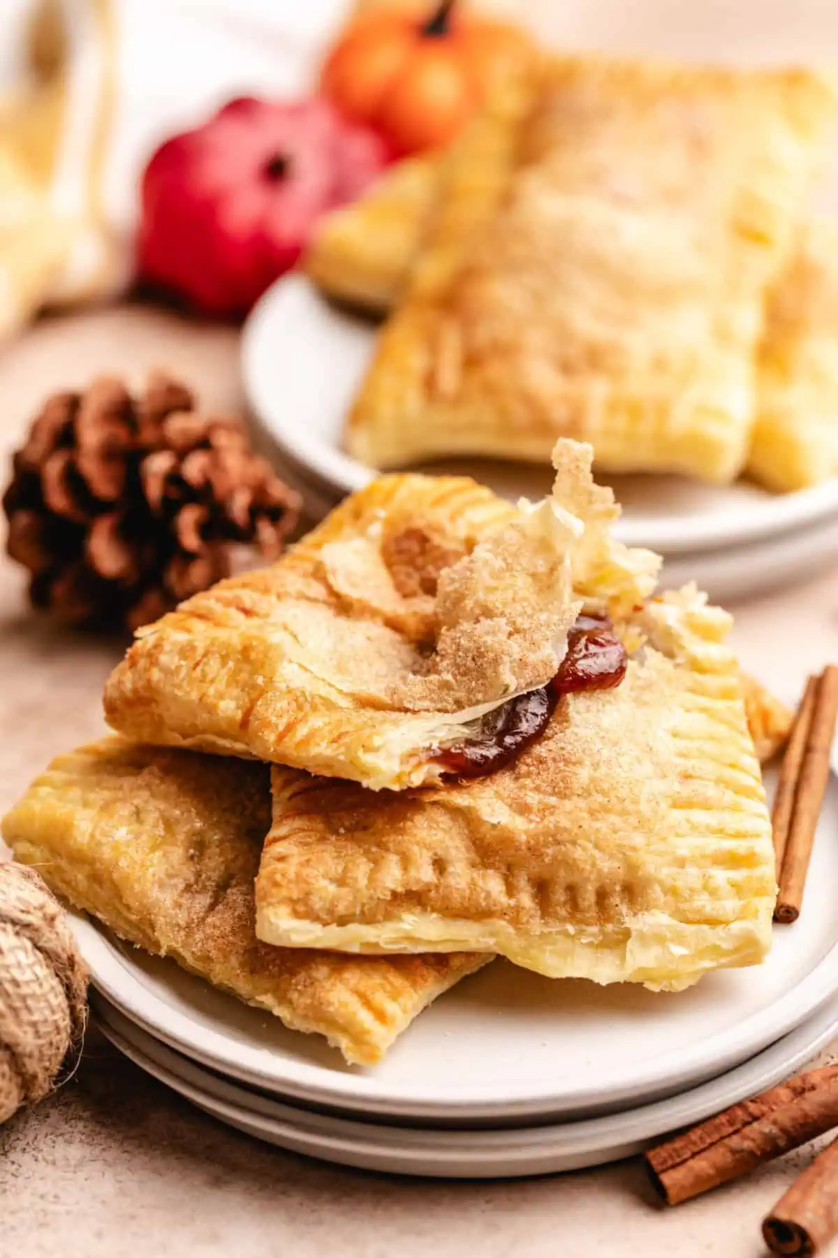 Hand-held pumpkin pies with a golden-brown crust and flaky layers.