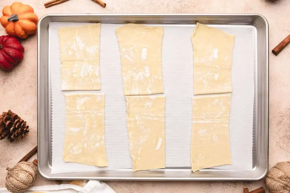 Puff pastry dough laid out on a baking sheet.