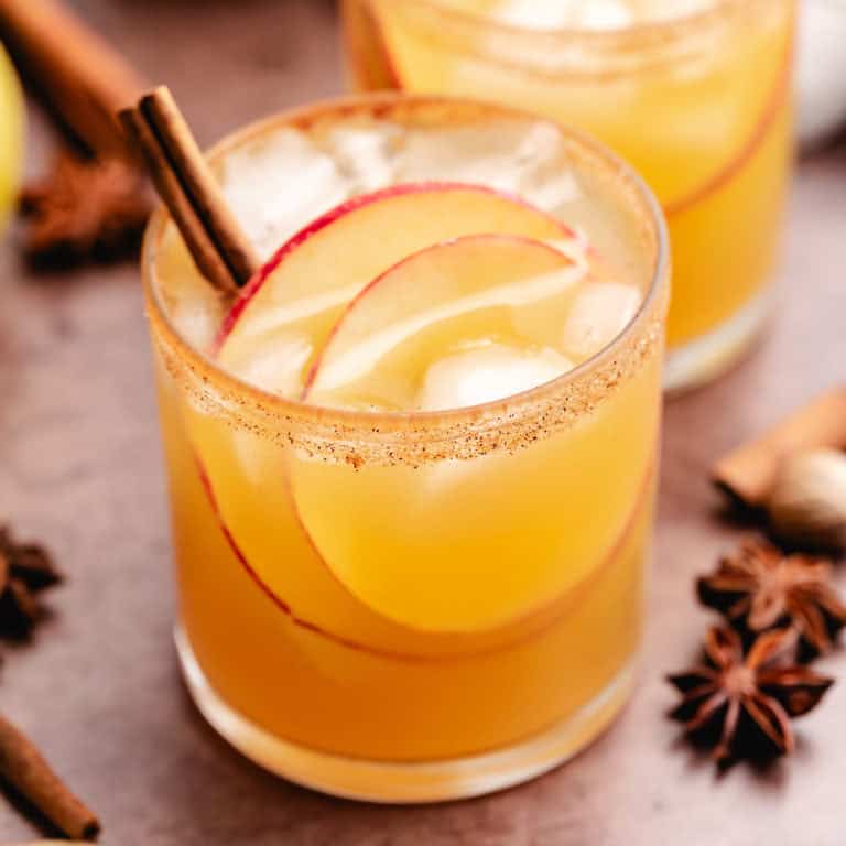 Close up view of fall apple cider margarita in a cocktail glass.