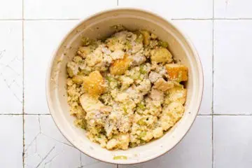 Cornbread dressing mixture in a large mixing bowl.