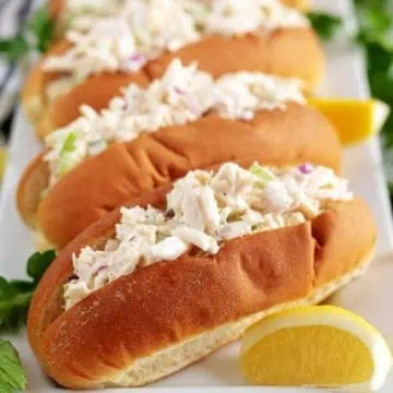 Crab rolls served on a platter with lemon.