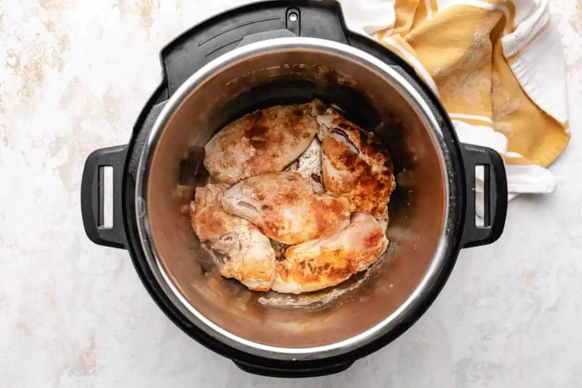 Top down view of chicken cooking in an instant pot.