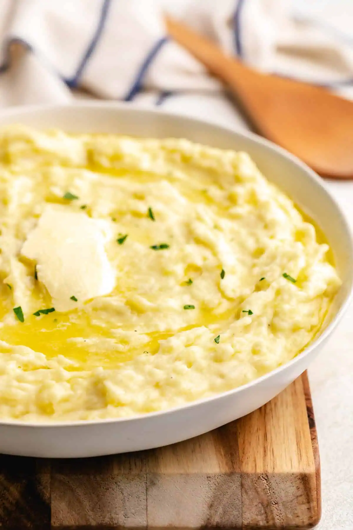 Tabs of butter on top of mashed potatoes.