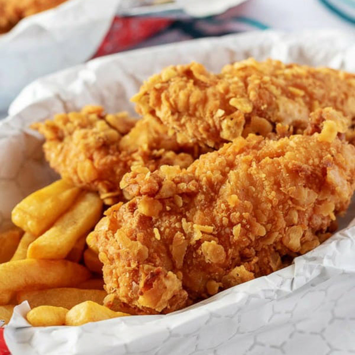 Crispy chicken tenders in a basket.