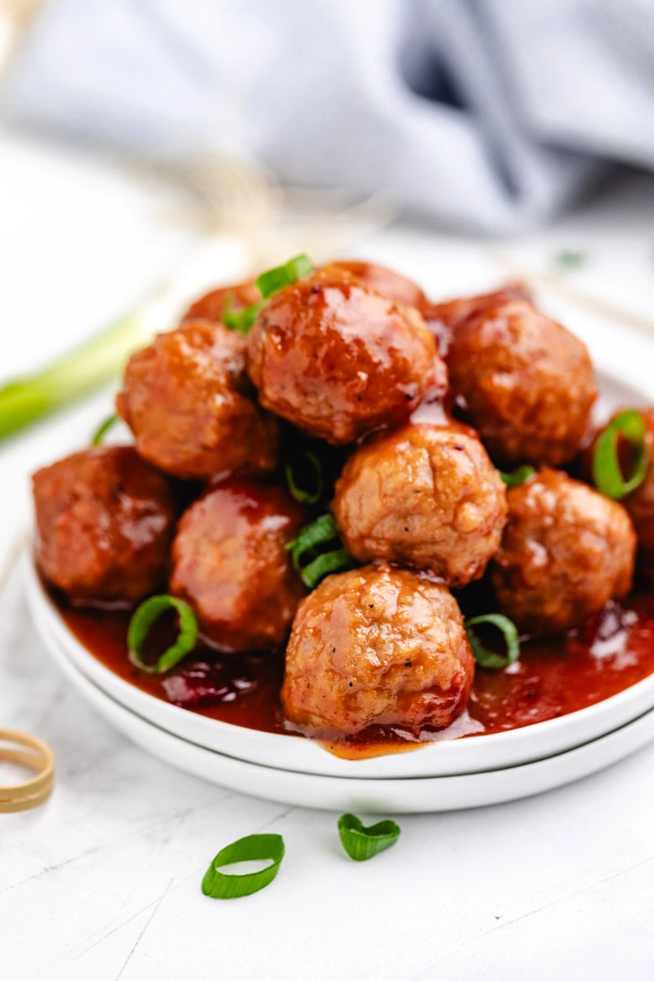 Cranberry bbq meatballs sprinkled with green onions.