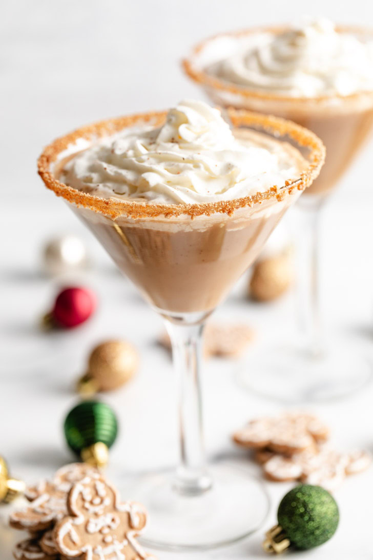 Close-up of gingerbread martini topped with whipped cream.