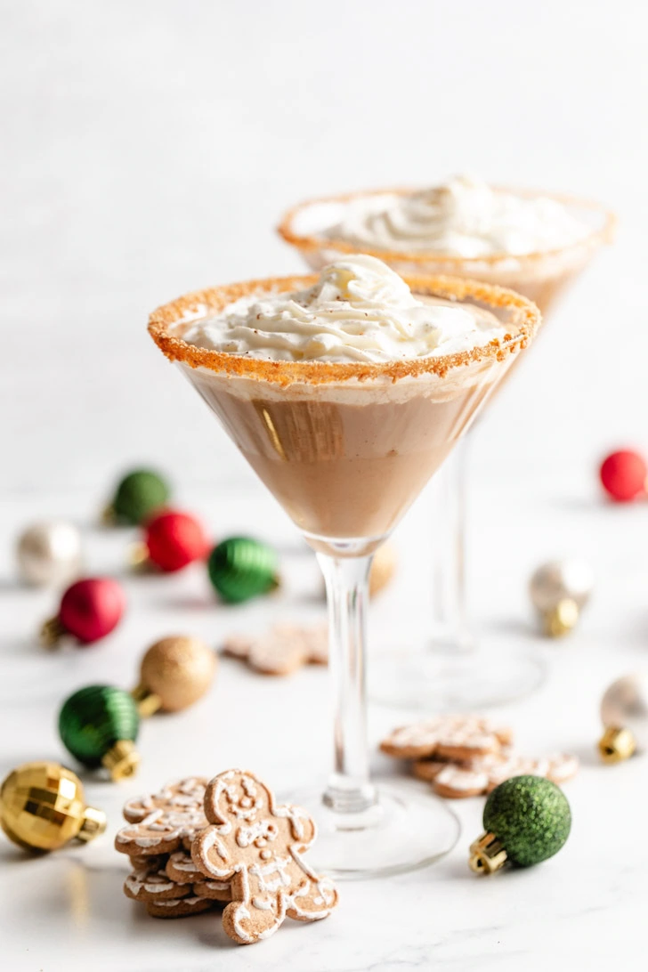 Holiday-themed gingerbread martinis with ornaments and cookies.