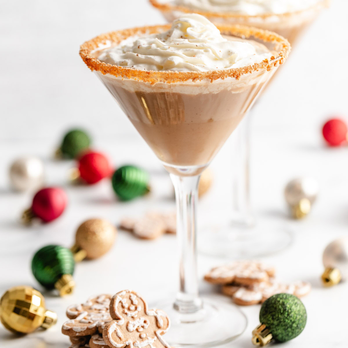 Gingerbread martini with whipped cream and a cookie crumb rim.