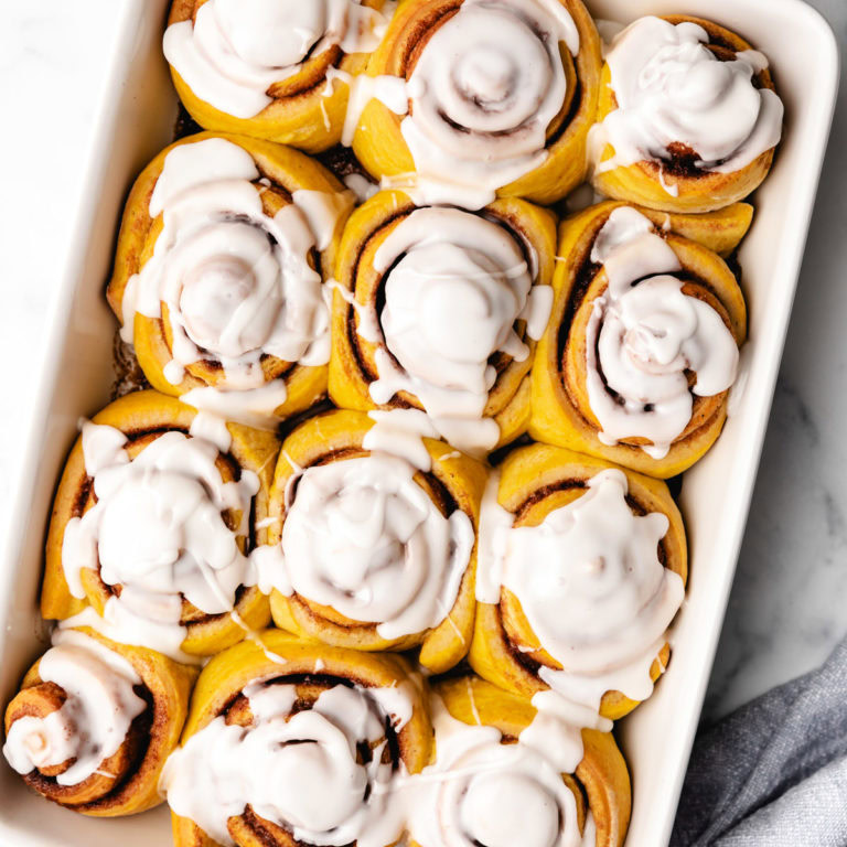 Close up view of cinnamon rolls in a pan.