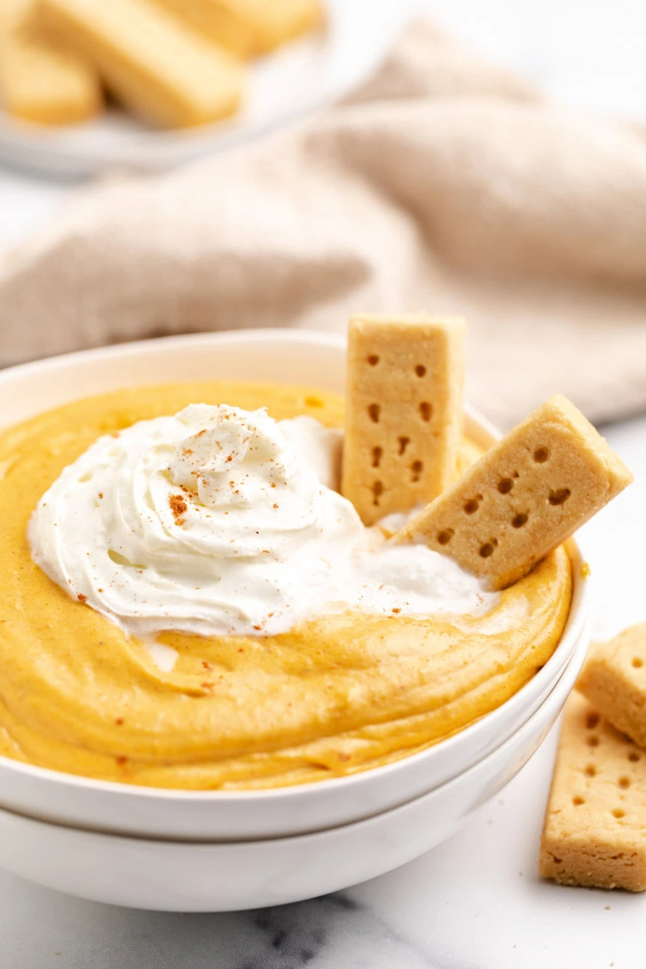 Cookies dipped into a bowl of dessert dip.