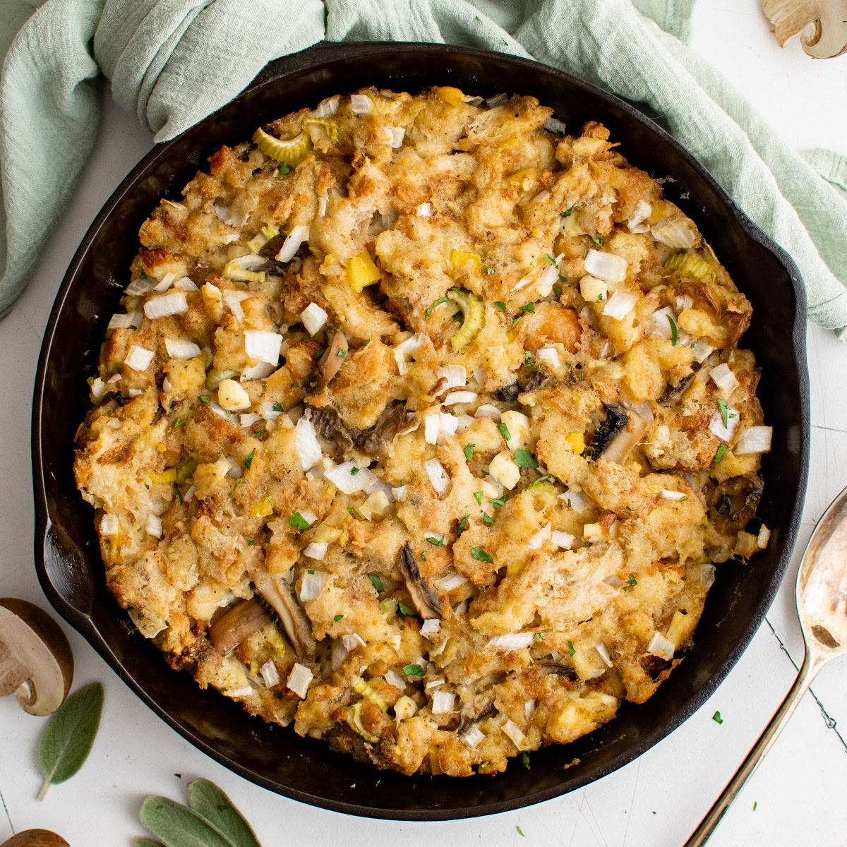 Overhead view of sage stuffing in cast iron.