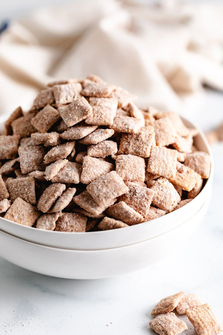 Classic snickerdoodle puppy chow on a marble background.