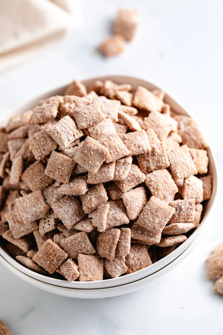 Holiday-themed cinnamon sugar cereal mix in a white bowl.