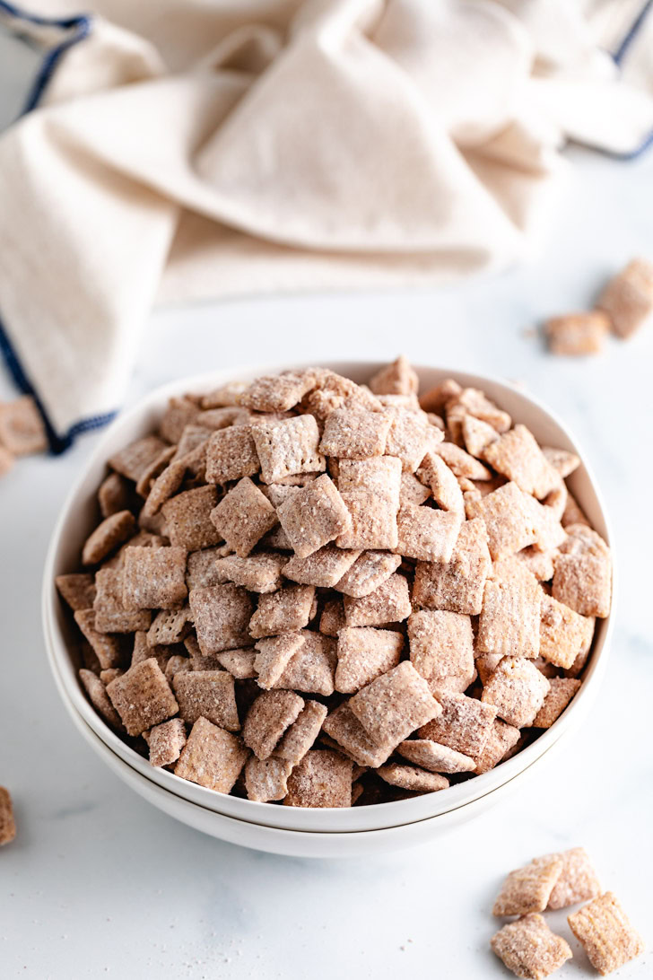 Sweet and crunchy cinnamon-flavored cereal snack mix in a serving bowl.