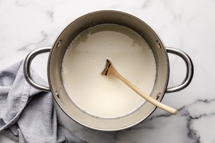 Warm milk and heavy cream in a pan.