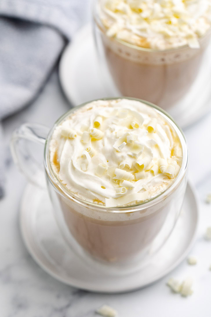 Hot white chocolate mocha in a glass coffee mug.